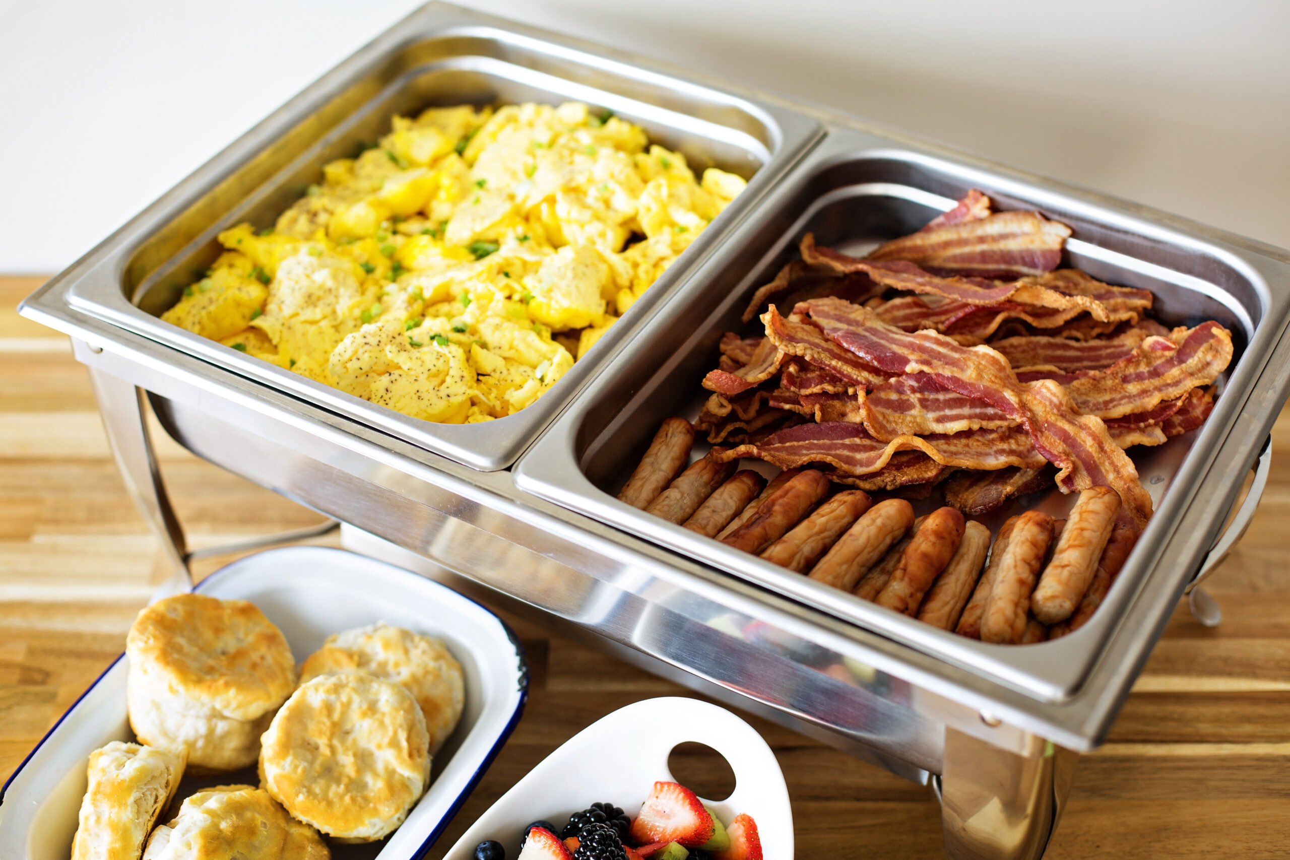 Breakfast buffet with scrambled eggs, sausage and bacon