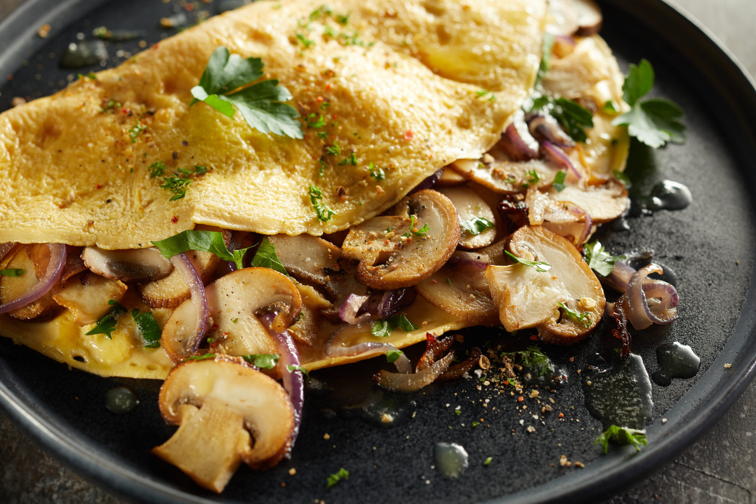 Tasty omelette with mushrooms on plate